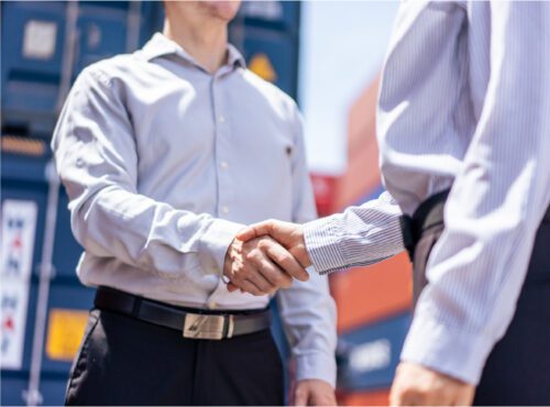 Two businesspeople agreeing on a sale